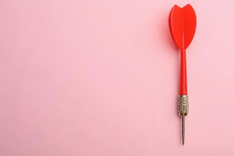 Red dart arrow on pink background, top view with space for text Stock Photos