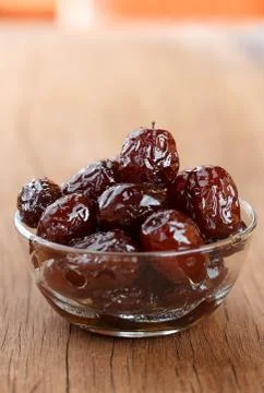 Red date syrup product in bowl on wood front view Stock Photos