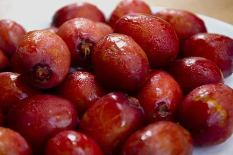 Red dates isolated on a ceramic plate Stock Photos