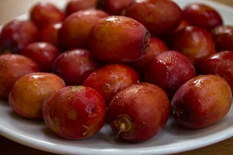 Red dates isolated on a ceramic plate Stock Photos