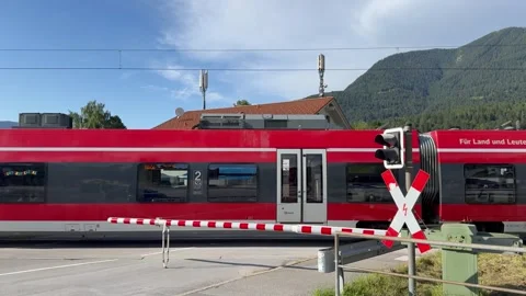 Red DB (Deutsche Bahn) regio train passes through Garmisch-Partenkirchen town Stock Footage 315669018