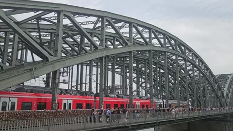 Red DB train and regional trains are passing Hohenzollern bridge. Koln, Germany Видео 341006135