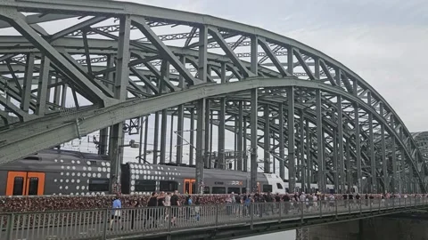 Red DB train and regional trains are passing Hohenzollern bridge. Koln, Germany Stock Footage 341006195
