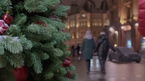 Red decorations in the form of berries on the tree. The city is decorated for Stock Footage 147735053