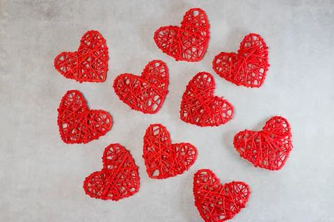 Red decorative hearts on a gray background. Valentine's Day Concept. Stock Photos