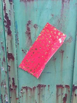 Red Decorative Paper Attached To Rusty Green Metal Stock Photos