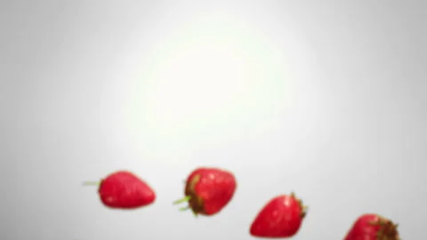 Red delicious strawberries are flying on the white background Stock Footage 125641853