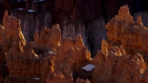 Red desert hoodoos stand under a soft evening light Stock Footage 329558440