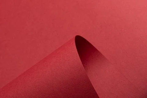 Red designer paper background with sharp fold and sculptural shape. Matte Stock Photos