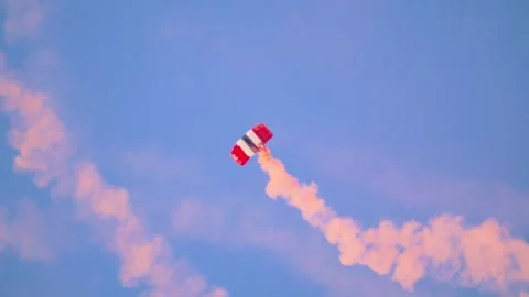 Red Devil British Army parachutist trails vibrant red smoke as they Stock Footage 285766105