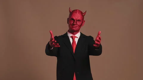 Red devil businessman character posing on brown background Stock Footage 300467215