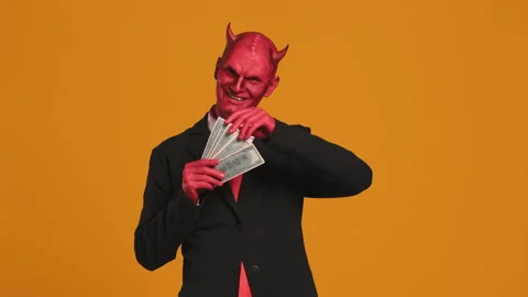 Red devil businessman counting money on yellow background Stock Footage 290102345