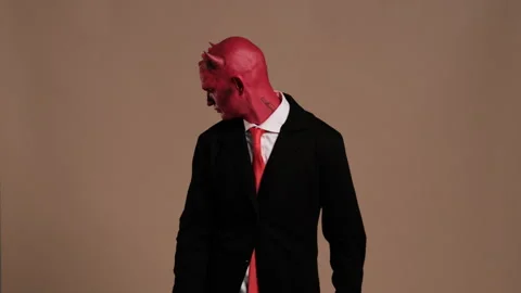 Red devil businessman making gestures on solid background Stock Footage 286354383