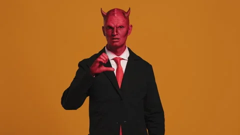 Red devil businessman making heart shape with hands Stock Footage 291297017