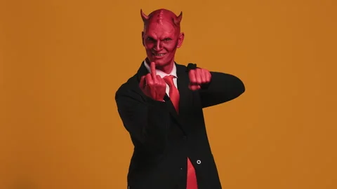 Red devil businessman pointing middle fi... | Stock Video | Pond5