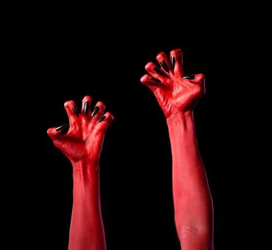 Red devil hands with black nails, real body-art Fotos de archivo