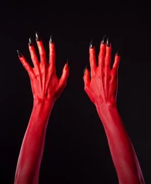 Red devil hands with black nails Foto stock