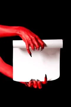 Red devil hands holding paper scroll 스톡 사진