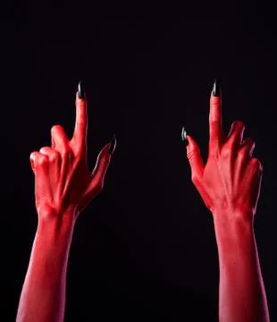 Red devil hands pointing fingers up Foto stock