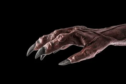 Red devil monster hand isolated on black background Stock Photos