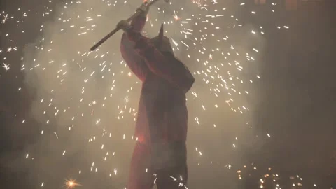 Red devil performer during Correfoc in Valencia, Spain, with fireworks and Stock Footage 299967786