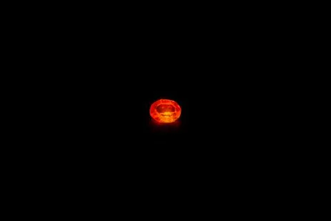 Red diamond on black background 스톡 사진