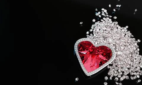 A red diamond or a large ruby in the shape of a heart, a symbol of love or .. Stock Photos