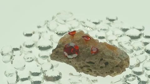 Red diamonds place on top of a chunk of raw opal. Stock Footage 252208196