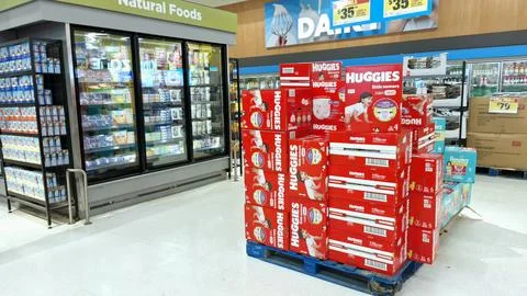 Red diaper boxes stacked inside grocery store aisle. Stock Photos