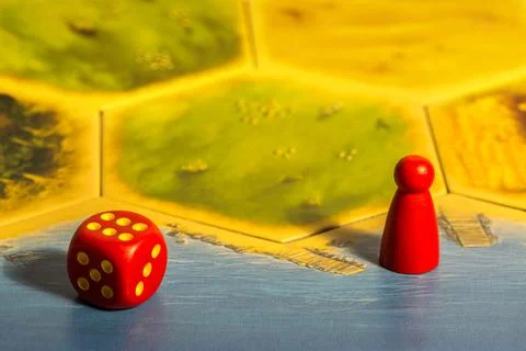 Red dice and red chip on game board Stock Photos