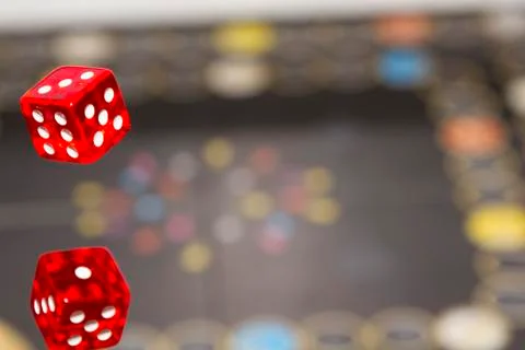 Red dice on dark background, concept of risk, gambling and chance. Copy space Stock Photos