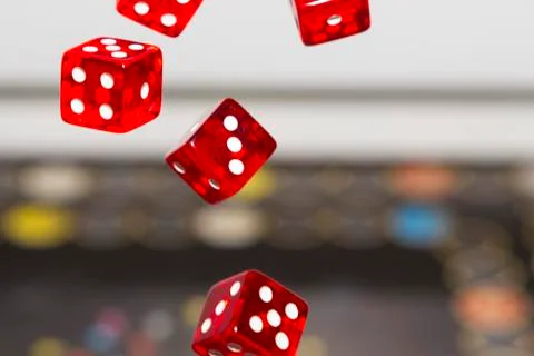 Red dice on dark background, concept of risk, gambling and chance. Stock Photos