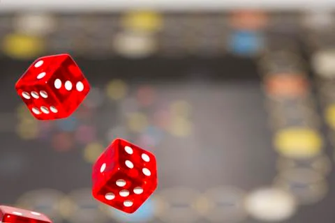 Red dice on dark background, concept of risk, gambling and chance. Copy space Stock Photos
