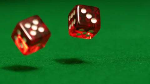 Red dice rolling on casino table Stock Footage