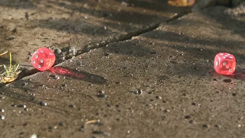 Red dice rolling on a concrete slab in slow motion hd Stock Footage 80046684