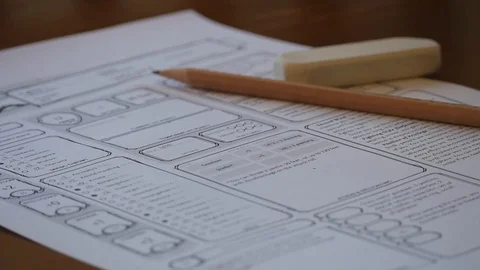 Red dice rolling onto D&amp;D character sheet Stock Footage 100310036
