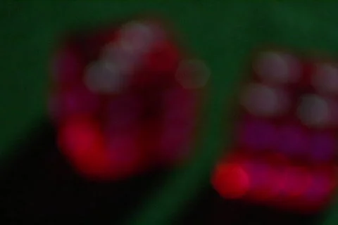 Red dice sit on a green table. Stock Footage 339965