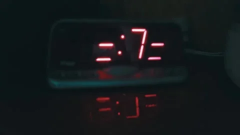 Red Digital Alarm Clock Display Glowing in Total Darkness Video stock 322534858