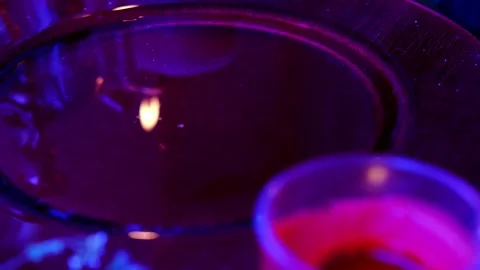 Red dish with water, reflections of lights of candles in liquid mysteriousl.. Stock Footage 246150486