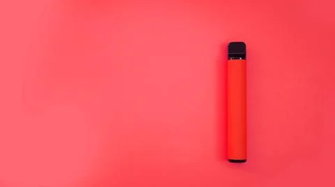 Red disposable electronic cigarette on bright red background Stock Photos