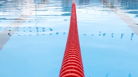 Red dividing strip in the pool, undulating water surface is visible Stock Footage 93461139