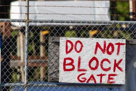 Red do not block gate sign on gate Stock Photos