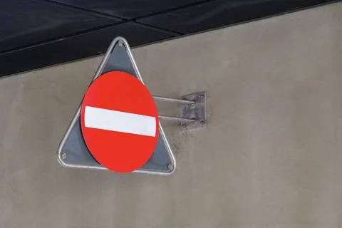 Red do not enter prohibition road sign on concrete wall Stock Photos