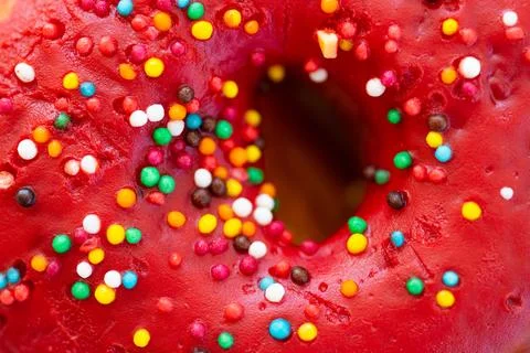 Red donuts with icing on white background. Sweet donuts. Stock Photos
