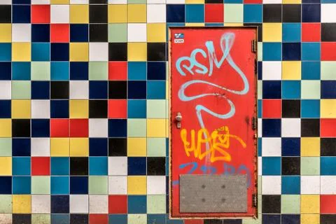 Red door in colored tiles Stock Photos