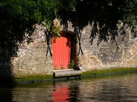 Red door at the side of a river Stock Photos