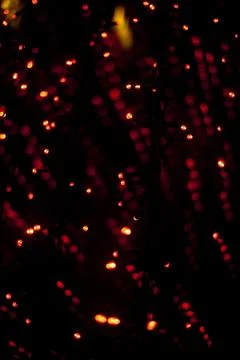 Red dots in space. Lights in dark. Red light bulbs. Lot of small lights in .. Stock Photos