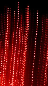 Red dotted lines of lights on a black background Stock Illustration