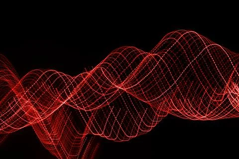 Red dotted lines of lights on a black background Stock Photos