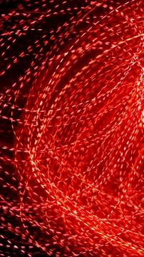Red dotted lines of lights on a black background Stock Photos